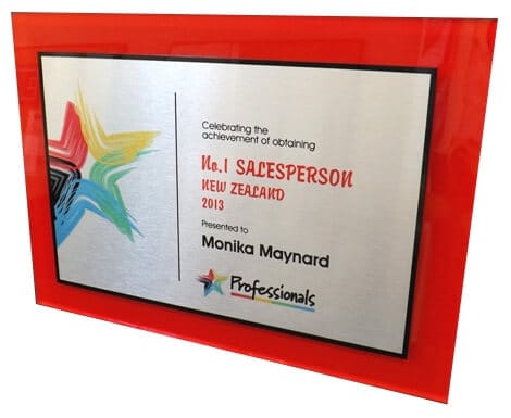 Large metal corporate awards plaque engraved with colour logos and text.